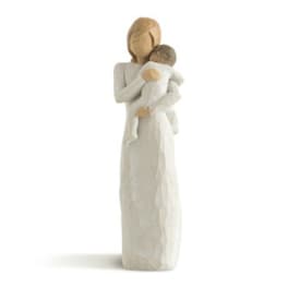 Carved figurine of an adult holding a child