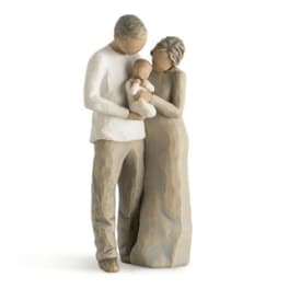 Wooden figurine of a couple holding a baby
