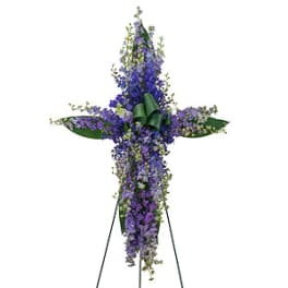Tall purple floral cross on a stand