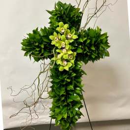 Green floral cross with orchids and twisting branches