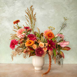 Colorful mixed flower arrangement in a white vase