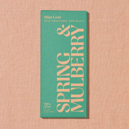 Green chocolate bar package on a pink textured background