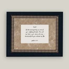 Framed wall art with a handwritten Bible verse on a beige background