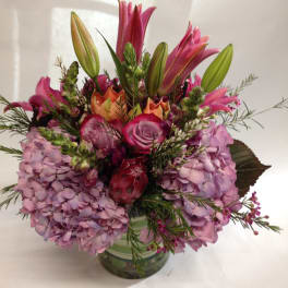 Pink and lavender floral arrangement in a glass vase
