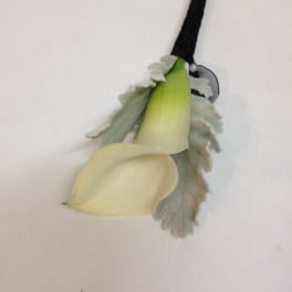 White calla lily boutonniere with gray foliage and black ribbon wrap