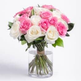 Pink and white rose bouquet in a clear glass vase
