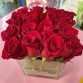 Bouquet of red roses in a clear square vase