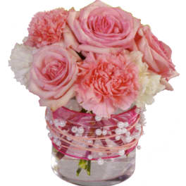 Pink roses and carnations in a clear vase with pearl accents