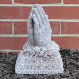 Prayer hands garden statue with floral detail and engraved text