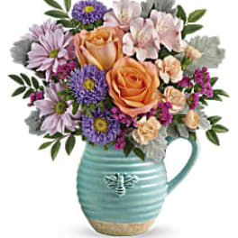 Mixed bouquet in a turquoise mug-shaped vase