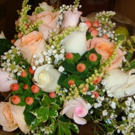 Bouquet of pale pink and white roses with small white filler flowers