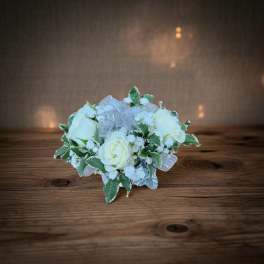Small bouquet of white roses with silver ribbon and variegated leaves