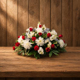 Red and white floral arrangement on a wooden table