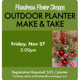 Holiday planter with evergreen branches, red berries, and red ornaments