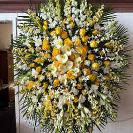 Large standing floral spray with yellow roses and white orchids