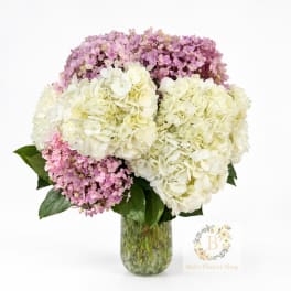 Pink and white hydrangea bouquet in a clear glass vase