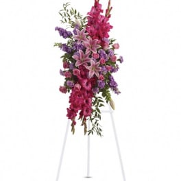 Tall pink and purple floral spray on a white stand