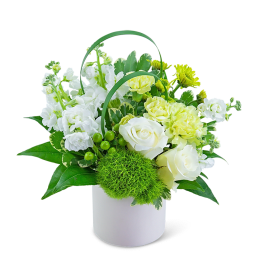 White and yellow floral arrangement in a white container with green handles