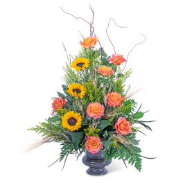 Orange roses and sunflowers in a dark vase