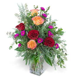 Bouquet of red and peach roses in a clear glass vase