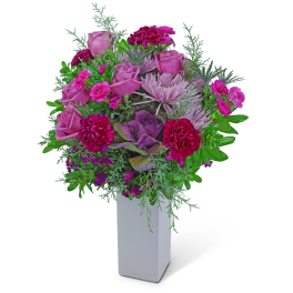 Pink roses and magenta carnations in a white vase