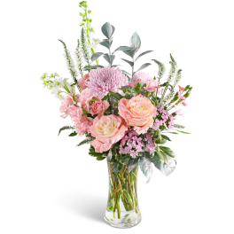 Pink roses and chrysanthemums in a clear glass vase