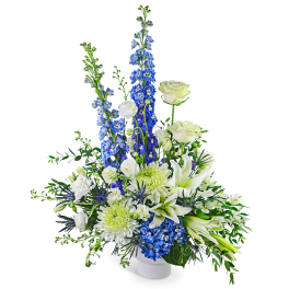 White and blue floral arrangement in a white vase