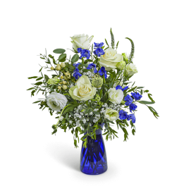 White roses and blue flowers in a cobalt glass vase