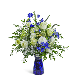 Blue and white floral arrangement in a cobalt glass vase