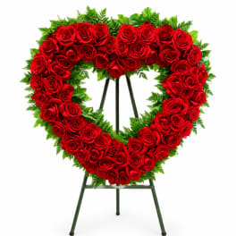 Heart-shaped red rose wreath on a standing easel