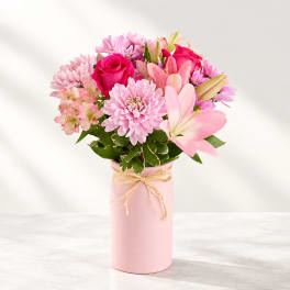 Pink bouquet with roses, lilies, and daisies in a pink vase
