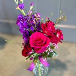Bouquet of pink and purple roses in a glass vase