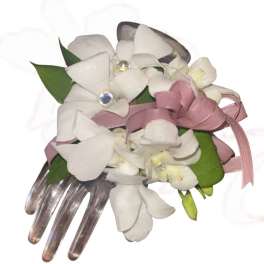 White orchid corsage with pink ribbon and jeweled accents on a clear comb