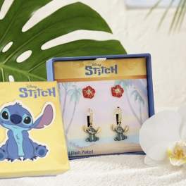 White orchid beside Stitch-themed jewelry boxes