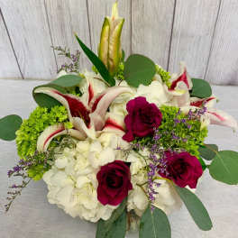 Bouquet of white lilies, hydrangeas, and deep pink roses