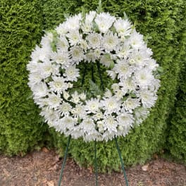 White chrysanthemum wreath on a standing easel