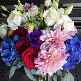 Bouquet of red and white roses with pink dahlias and blue hydrangeas
