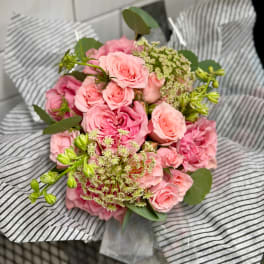 Pink rose bouquet wrapped in striped paper