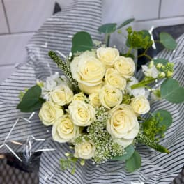 Bouquet of cream roses with white filler flowers and greenery