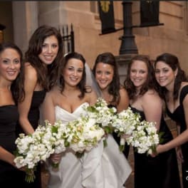Bride and bridesmaids holding white bouquets