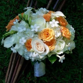 Bouquet of white and orange roses with small white flowers