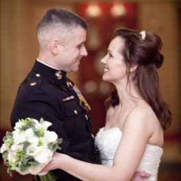 Bride and groom holding a white wedding bouquet