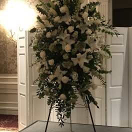 Large white floral standing arrangement on an easel
