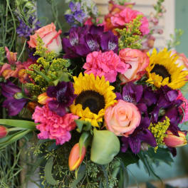 Bouquet with sunflowers, roses, carnations, and purple blooms