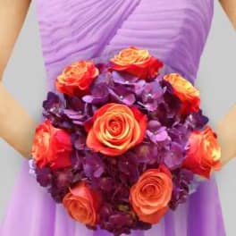 Bridal bouquet of orange roses and purple hydrangeas