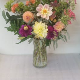 Mixed bouquet of dahlias in a clear glass vase