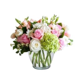 Pink and white rose bouquet in a clear glass vase