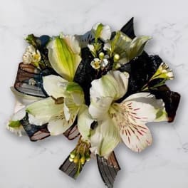 White and pale green flower bouquet with dark ribbon accents