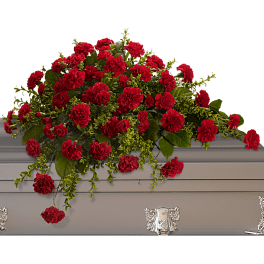Red carnation arrangement in a gray casket