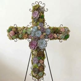 Cross-shaped succulent arrangement on a metal stand